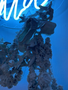 Detailed view of soda-fired slip-dipped thistles, lilacs, stargazer lilies, and ballet pointe shoes