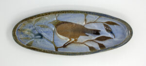 All pieces are dipped in slip, bisque fired, hand painted with wax resist designs, and dipped in a contrasting slip.