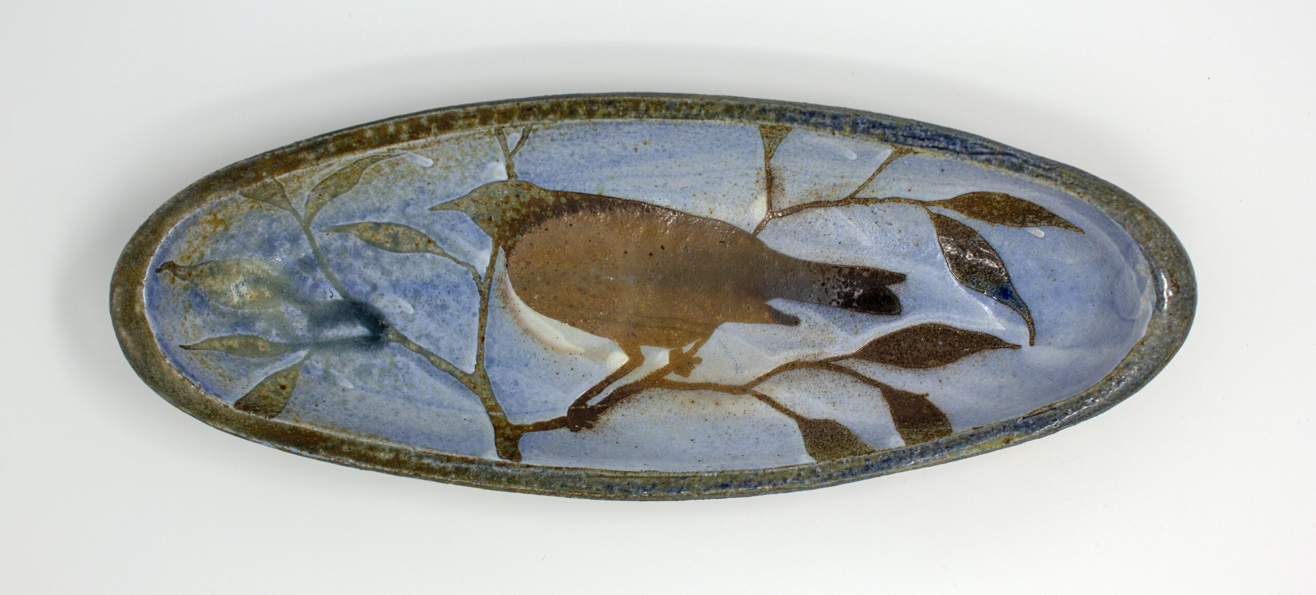 All pieces are dipped in slip, bisque fired, hand painted with wax resist designs, and dipped in a contrasting slip.