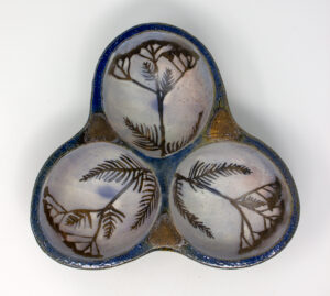 All pieces are dipped in slip, bisque fired, hand painted with wax resist designs, and dipped in a contrasting slip.