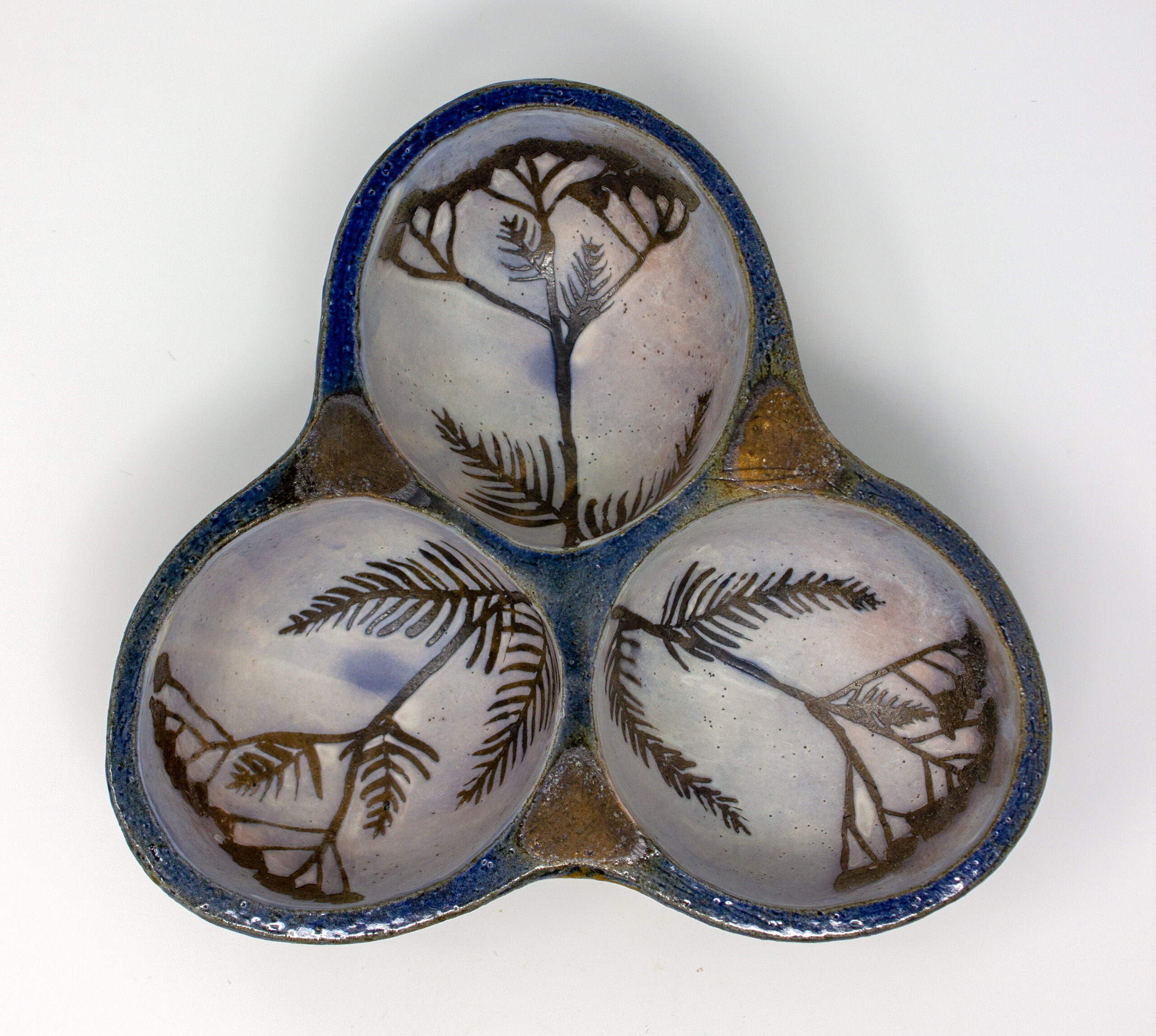 All pieces are dipped in slip, bisque fired, hand painted with wax resist designs, and dipped in a contrasting slip.