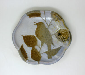 All pieces are dipped in slip, bisque fired, hand painted with wax resist designs, and dipped in a contrasting slip.