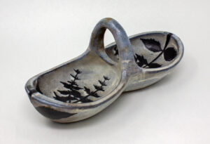 All pieces are dipped in slip, bisque fired, hand painted with wax resist designs, and dipped in a contrasting slip.