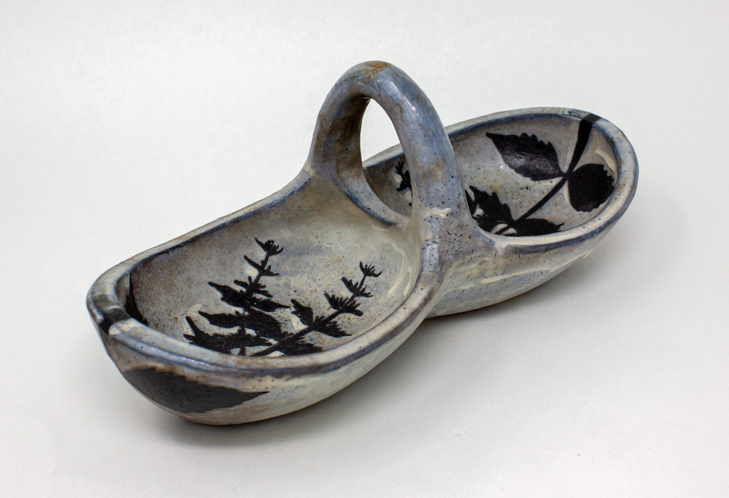 All pieces are dipped in slip, bisque fired, hand painted with wax resist designs, and dipped in a contrasting slip.