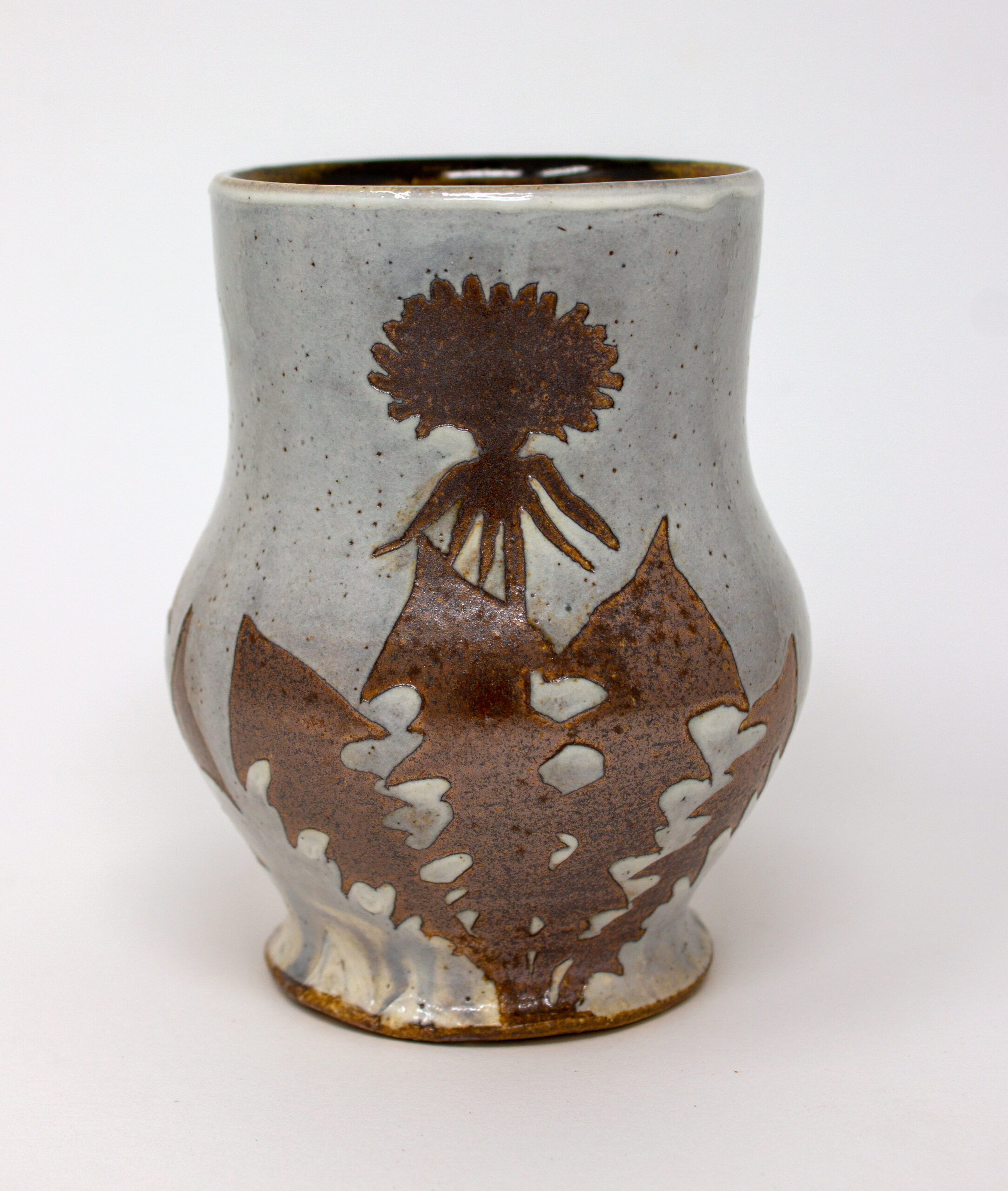 All pieces are dipped in slip, bisque fired, hand painted with wax resist designs, and dipped in a contrasting slip.