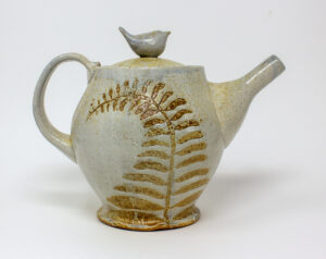 All pieces are dipped in slip, bisque fired, hand painted with wax resist designs, and dipped in a contrasting slip.