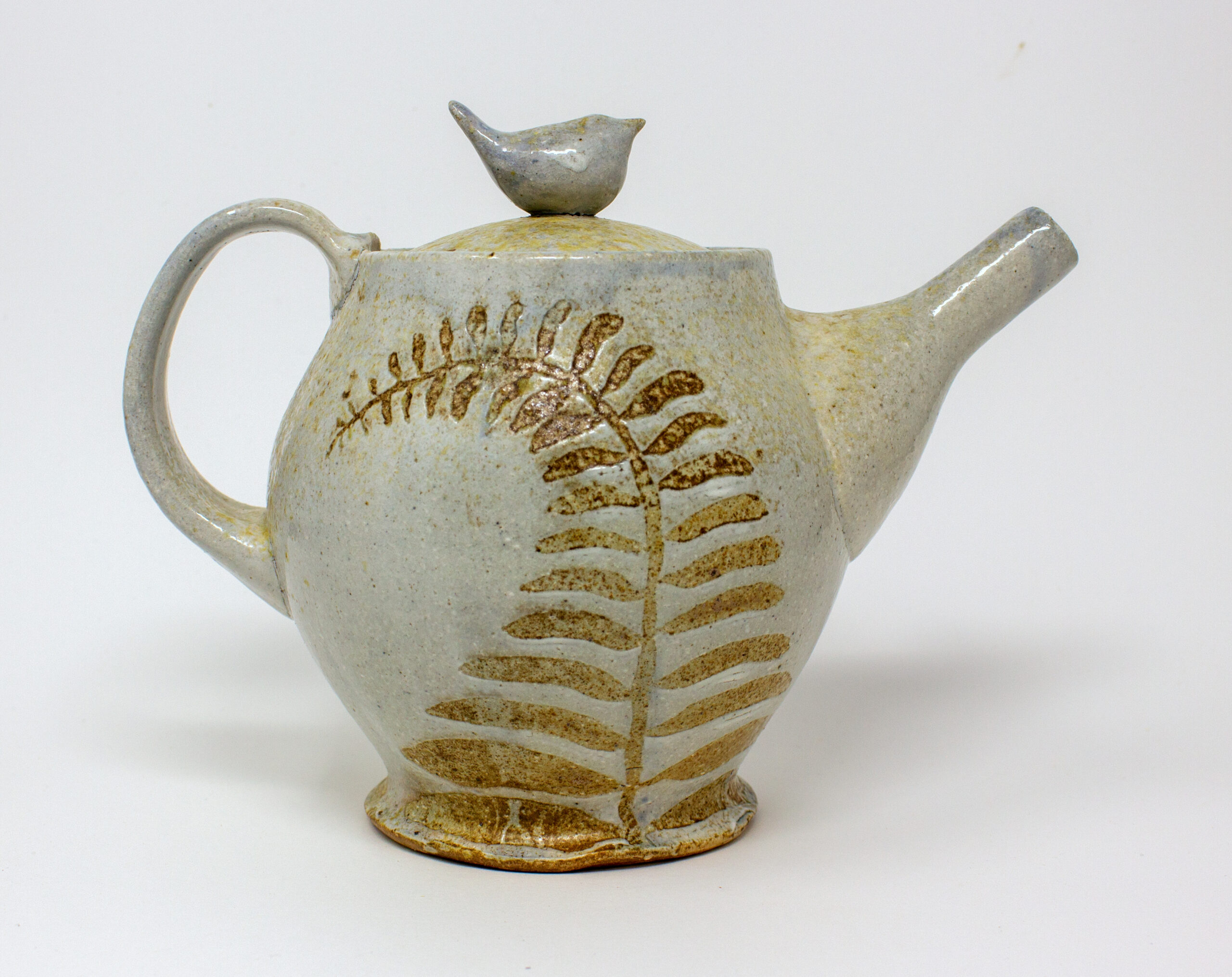 All pieces are dipped in slip, bisque fired, hand painted with wax resist designs, and dipped in a contrasting slip.
