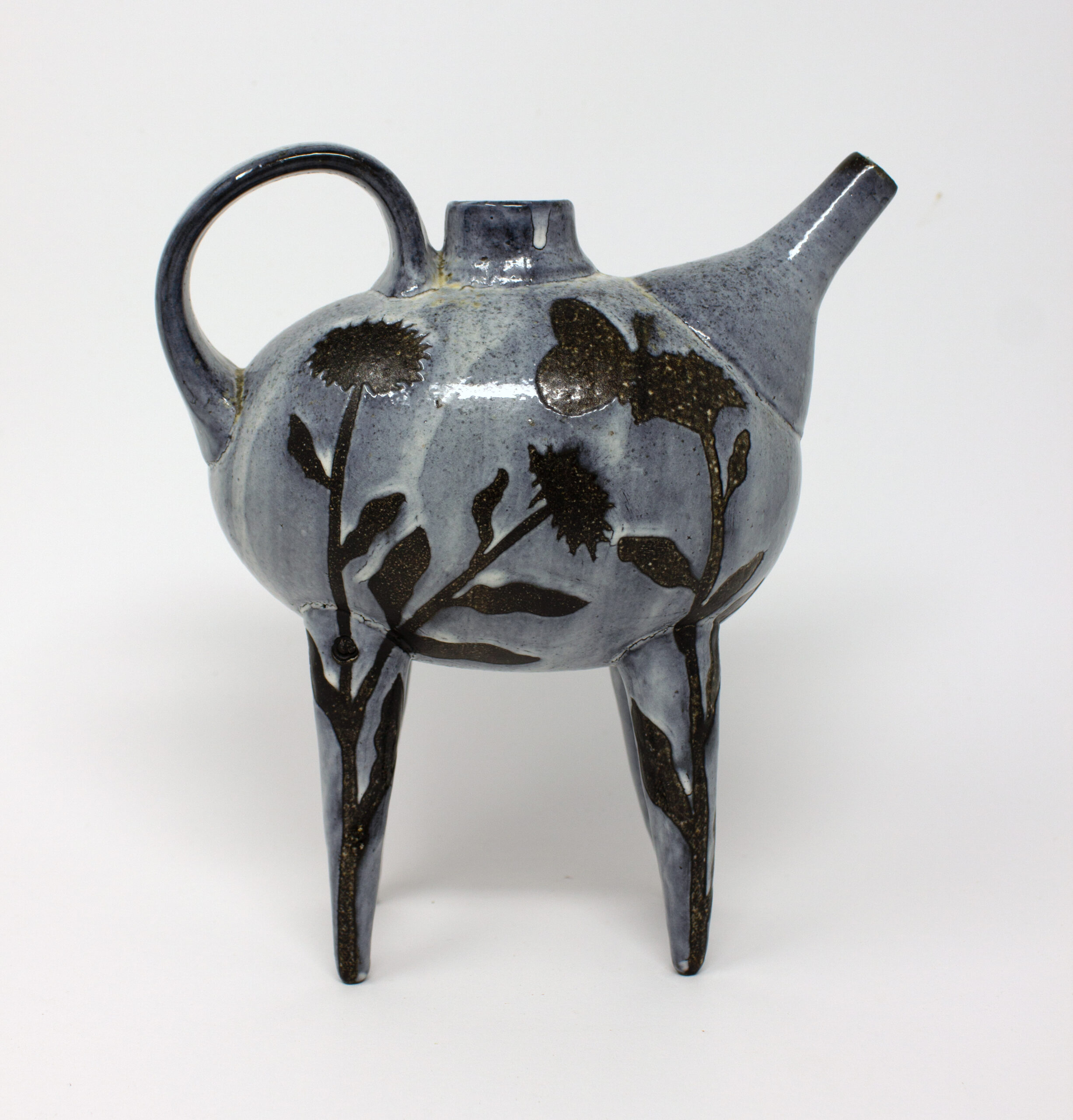 All pieces are dipped in slip, bisque fired, hand painted with wax resist designs, and dipped in a contrasting slip.