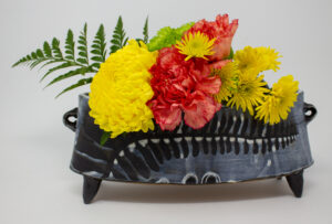 All pieces are dipped in slip, bisque fired, hand painted with wax resist designs, and dipped in a contrasting slip.