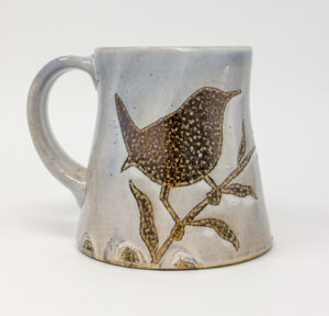 All pieces are dipped in slip, bisque fired, hand painted with wax resist designs, and dipped in a contrasting slip.