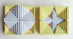 Referencing traditional quilting squares, "(Im)mutability" upholds the beauty of textiles while shifting the typically soft forms to hard blocks that can be rearranged. The shift questions the permanence of comfort & belonging while showing that if one formation is lost, a new pattern can be created