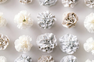2017, 49" x 109" x 3", Handbuilt porcelain flowers & real carnations, Photo credit: Eric Mueller