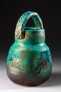 wheel thrown flower basket with textured slab handle and paddled texture on basket, glazed in my semi-matte turquoise glaze - left thinner at bottom to turn black and show variation in color  and some flashing of glaze, fired to 2300 degrees  F. in oxidation