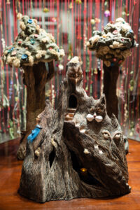 The Mountain in this installation represents the safe place for women to live to their fullest of being, or one's truest self. The Mountain holds a secret inclosure of women living and loving, safe but under a watchful eye.