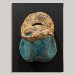 Stoneware wall pouch is highly textured with material and slab built.  Red iron oxide stain is painted on handle and top of pouch  and then wiped off to highlight the texture made by pressing  lace patterns onto the clay. Inside of the pouch and bottom are glazed in my turquoise semi- matte glaze. Fired to cone 6 in oxidation and mounted on painted wood that is wired on the back to hang on the wall like a painting. Can hold water to display fresh flowers.