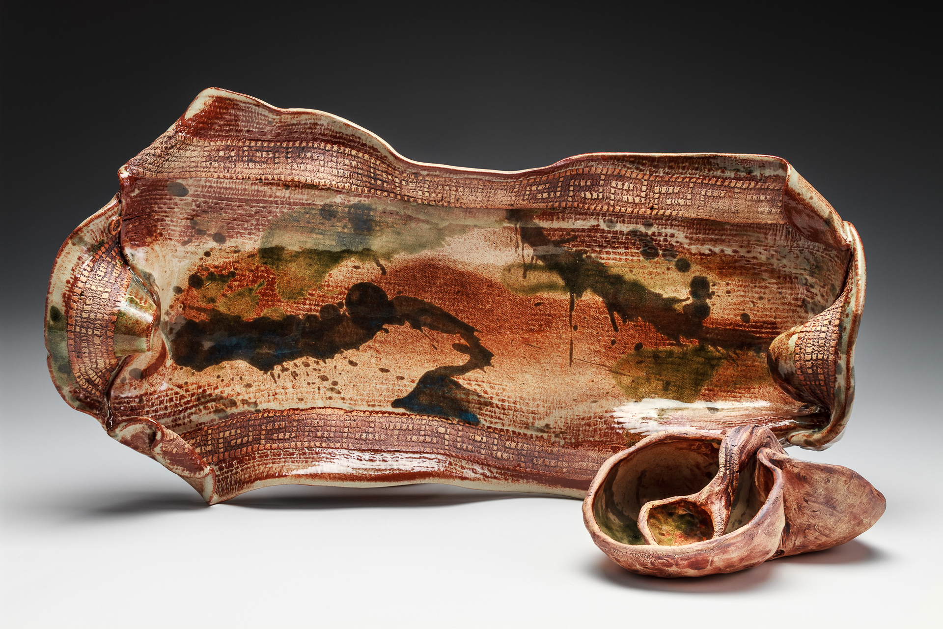 This highly textured sushi set includes a functional white stoneware slab tray with handles and a matching 2-lobed pinch pot condiment set with a pinched clay spoon. It is stained and glazed and fired to cone 6 in oxidation and is microwave and dishwasher safe  with lead free glaze mixed up in my studio.