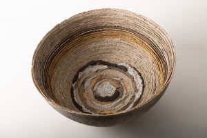 Slab pressed into a mold, white, yellow, gray, beige clay, volcanic & crackle glazes, decorated with gold luster.