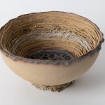 Slab pressed into a mold, white, white & yellow clay, volcanic & crackle glazes, decorated with gold luster.
