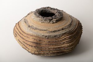 The volcanic glaze is brushed on the top and on the texture edge.  Yellow clay fired to cone 6