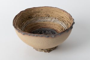 Slab pressed into a mold, white, white & yellow clay, volcanic & crackle glazes, decorated with gold luster.