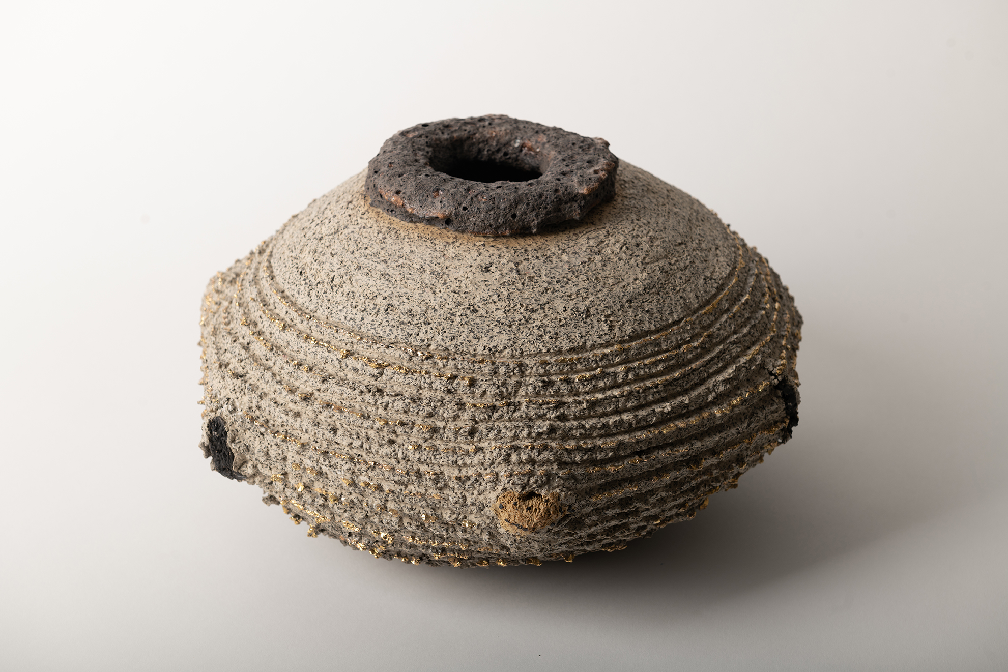 Volcanic glaze is btushed on the rim ,  gold luster brushed on the texture edges.