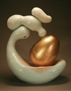 The surface is colored terra sigillata that has been burnished.  The egg form is painted.