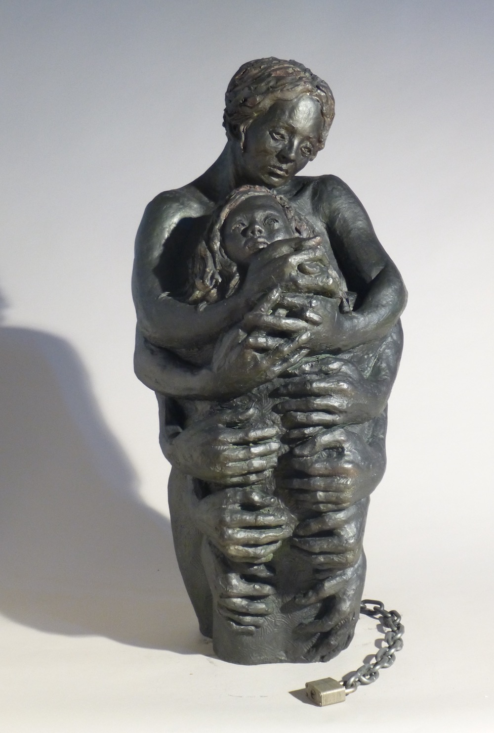 Over-Protective Mother is about parenting that restricts a child from exploring their  world due to a mother's fear. Thus, the child is held too tightly with a lock from the love of the mothers powerful braid.