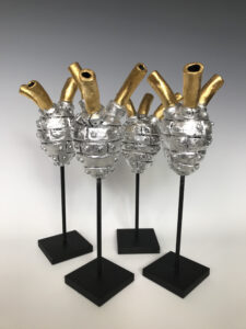 Gold and silver leafing on black steel stands