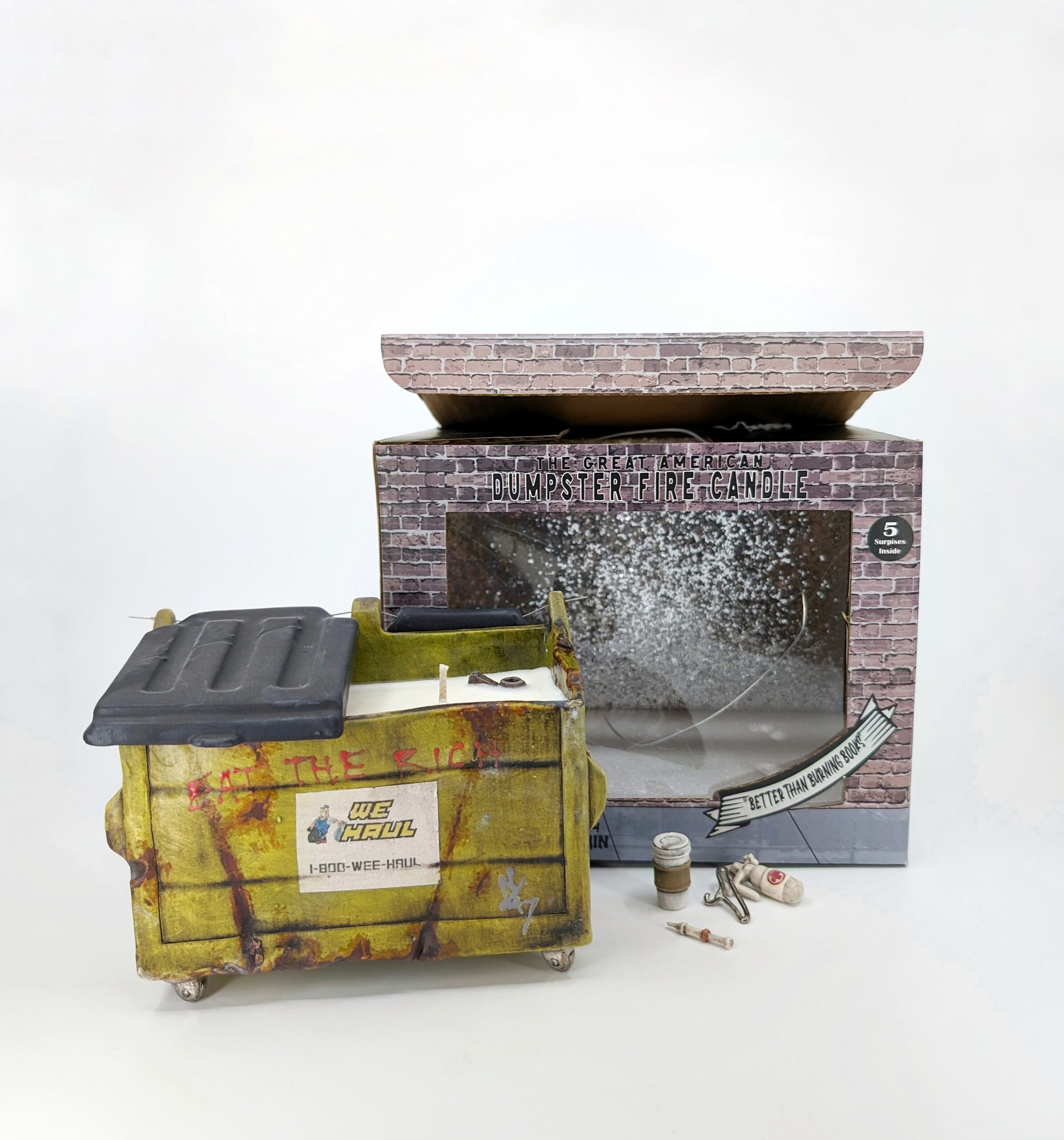Carly Slade. Dumpster Fire commemorative candle. It comes with custom cardboard box and miniature ceramic items inside the wax
