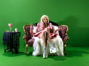 Portrait, 2021 

Video, portraiture, and performance have been used extensively as a way to express identity, especially identities of us non-normies. These three mediums have the ability to exist within the world with a boundarylessness when representing the presence of the body. The history of portraiture is one that is explicitly connected to the representation of the western upper classes, existing as one of the earlier avenues of expression that visually represents the idea of world making, or in other words, the “wish-landscape.” These two facts about portraiture is also what makes it so useful when representing non-normies against and within normal culture. Similarly to how opulence can be employed, the iconic nature associated with  representationally massive oil painting allows for the insertion of a queer body into that space demonstrating that non-normies can and will exist in that space. Flipping the iconic and traditional use of the medium on its head to critique the system and class that historically lays claim to it.