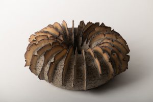 The volcanic glaze is brushed on the texturs  edges. Gray & yellow clay