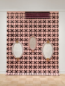 2021, Terracotta, Monoprinted flocked wallpaper, rhinestones, Fringe

This piece explores the complex nature of identity as a universal concept, examining how identity develops and changes through time as a fluid thing. On a more specific level I want to bring up the politics of the body in relation to the feminine and the masculine as something that is intertwined, existing within a spectrum rather than within a system made up of binaries.
Dimensions: wallpaper is 10' across mirrors are 41"Hx26"W