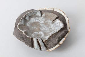 Gray  stoneware combined with porcelain, decorated with gold luster.