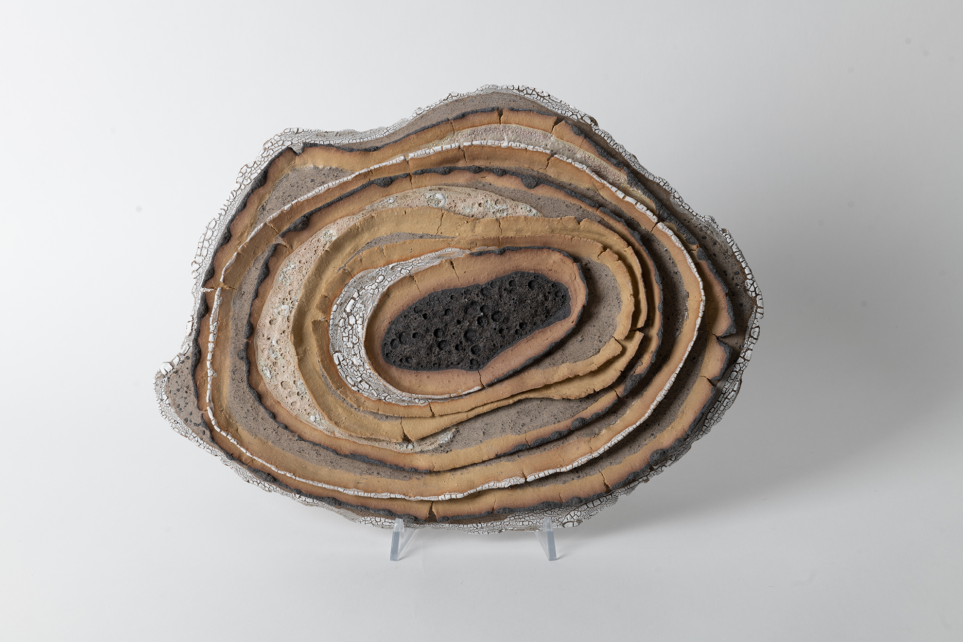 The layers are built from gray and yellow clay . volcanic and crackle glazes decorated with gold luster
