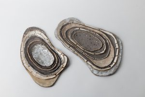 The layers are built from porcelain  and white, gray & beige clay. Decorated with gold luster.