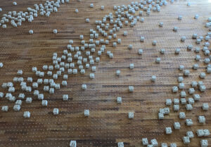 An 'event' (in Physics) is a moment specific to a place and time where a physical situation or occurrence is associated with a point in spacetime.
Seeking to combine the different ways I represent time, I create these ‘events’ that bring together the representation of moments in time (tiny cubes)  and the continuous cycle of time (big cubes) in site-specific installations. I place each cube, one by one, in a grid along the floor. Being on the floor and on the same plane as the viewer forces the viewer to confront the work and to become consciously aware of their body in space and time.
