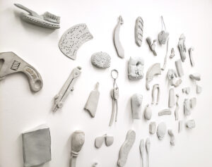 distorted porcelain objects on a white wall