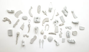 distorted porcelain objects on a white wall