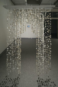 Raining Petals is an interactive work inviting touch, that plays with light and shadow while creating sound. It creates a chime noise when touched and walked through. Image by Larry Gawel