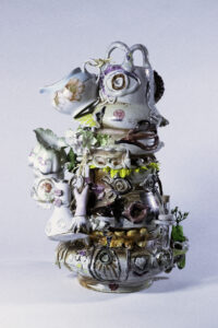 Goddess Totem is three separate vessels stacked on top of each other. Together they create one larger piece referencing the form of a community.
The creamers are a direct nod to feminine power and bodies as life givers. 
Despite being a functional vessel(s) the piece is much to ornate for everyday use. Rather, the ornaments(fruits) suggest a season of harvest and/or springtime and a celebration of life.