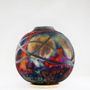 The full copper matte glaze provides a striking finish to the vase, making it an instant contrast to any interior. With an iridescent splash of metallic-like colors and unique patterns covering the vase’s body after Raku firing, no two pieces are the same.