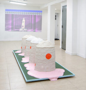 Audio from the video(excerpt in next submission) is playing thru loud speakers embedded in the ceramic sculptures.  Pink viscous substance slowly emanates out of the sculptures throughout the opening night and following days of the exhibition.  Constantly moving viscous substance is meant to challenge a traditional reading of this installation.  Image courtesy of Wick Gallery, Brooklyn.

Full Video is 8:28 and is integrated into an installation. Appropriated spoken text and imagery is in the background of a sculptural ceramic container expelling waste which can be compared to the sculptures in the installation. Themes of longing, homesickness, and the sea are brought together in this collaged video display

video clip can be found here: https://vimeo.com/299068053