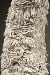 Handmade porcelain beads strung on to wire, over an armature, to create the form.