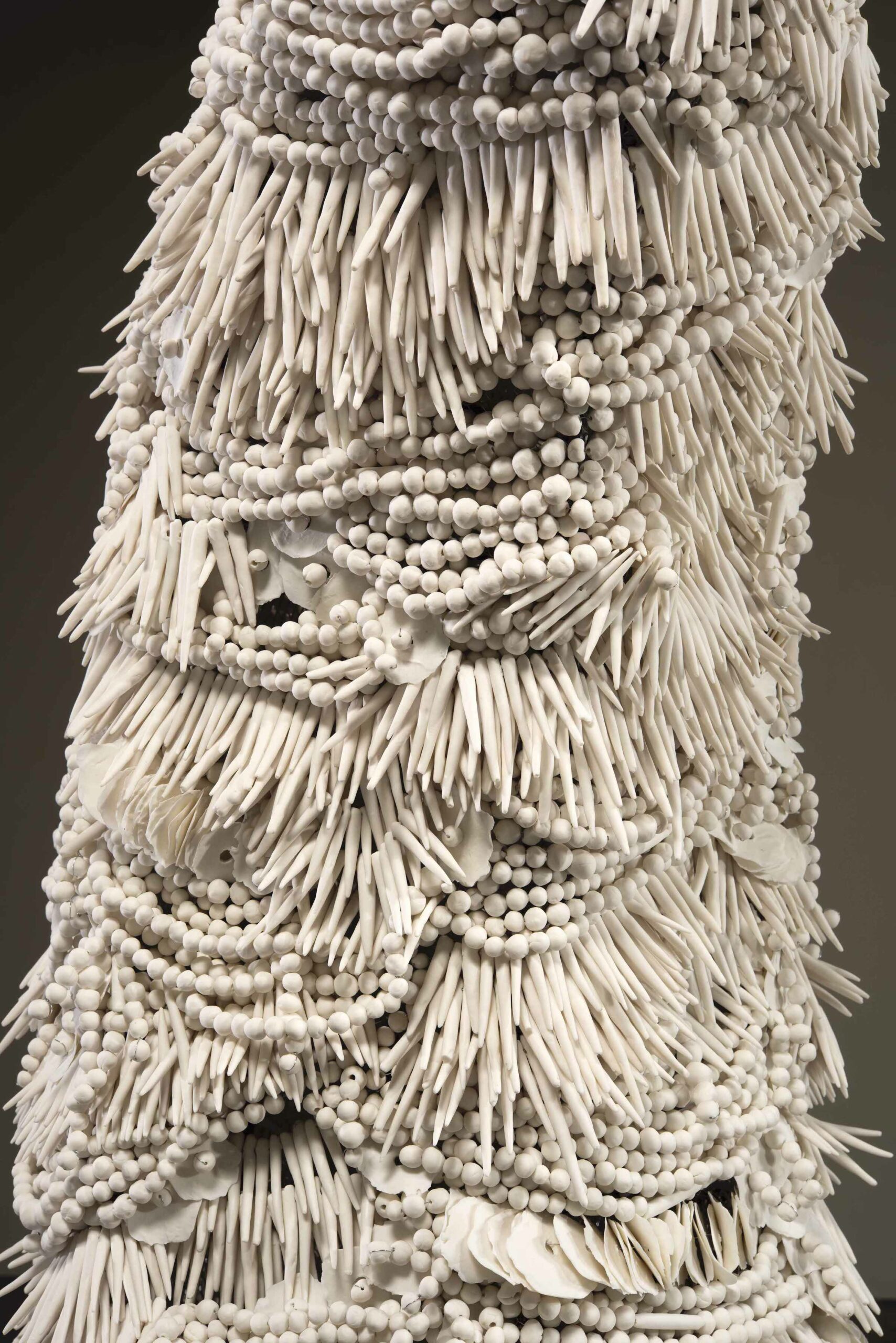 Handmade porcelain beads strung on to wire, over an armature, to create the form.