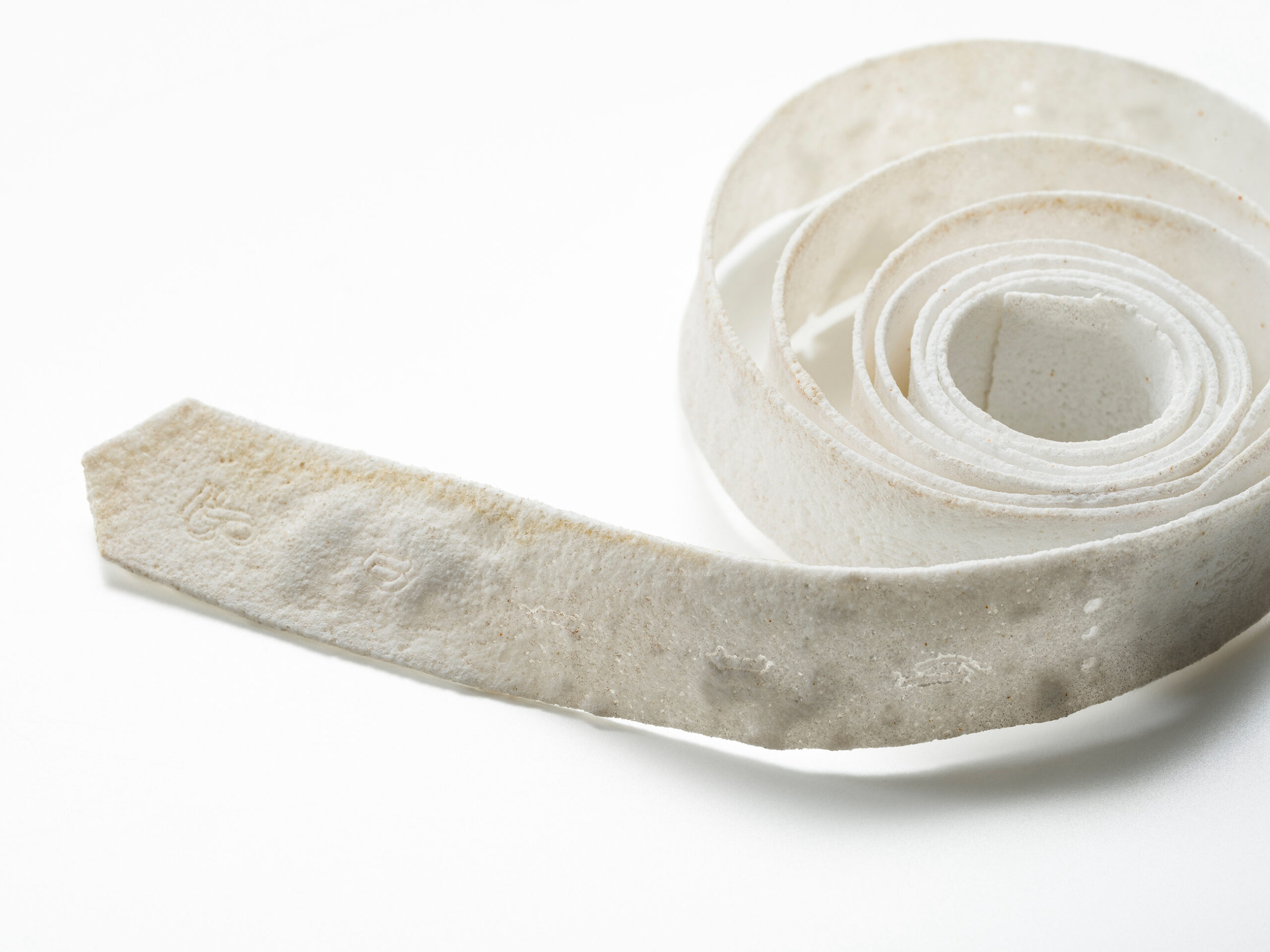Material: Ceramic
Making Process:  Tape-casted, laser cutter used to outline text.