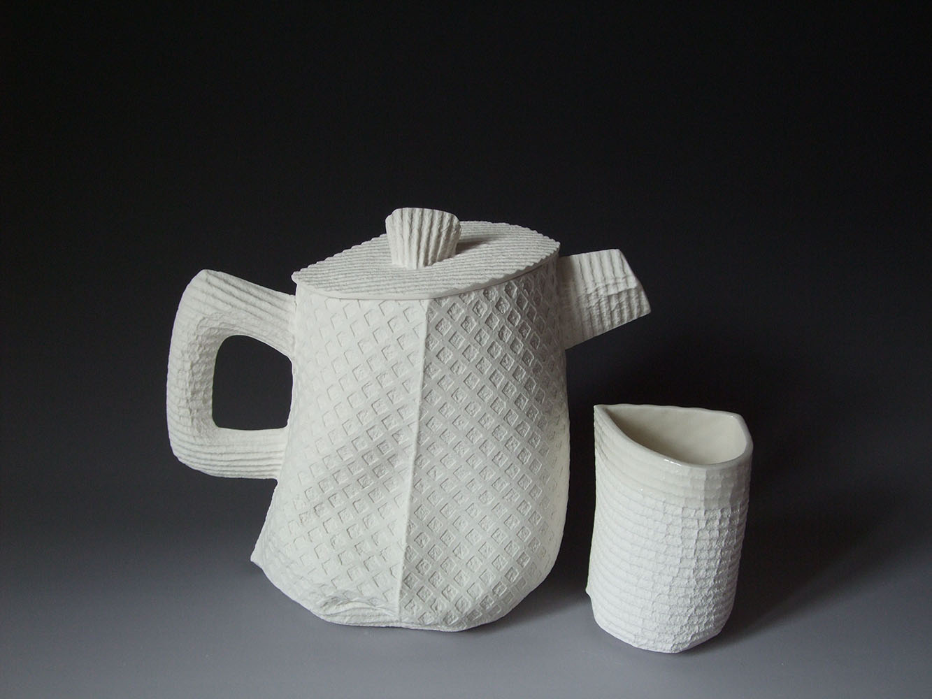 This series won an Honorable Mention award in Mino Japan in 2010. The work was made from flat cellulose sponges that have been sewn together to make soft, single use molds for porcelain slip.